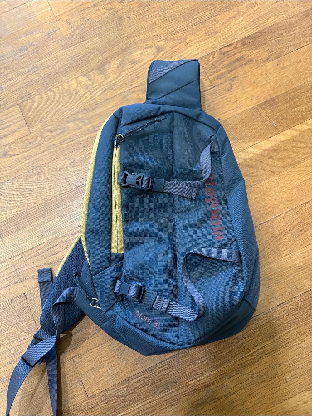 Patagonia Navy Sling Bag with Yellow Zip Accent